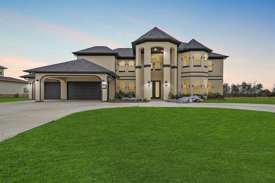 This home has a circle driveway, and an oversized garage.