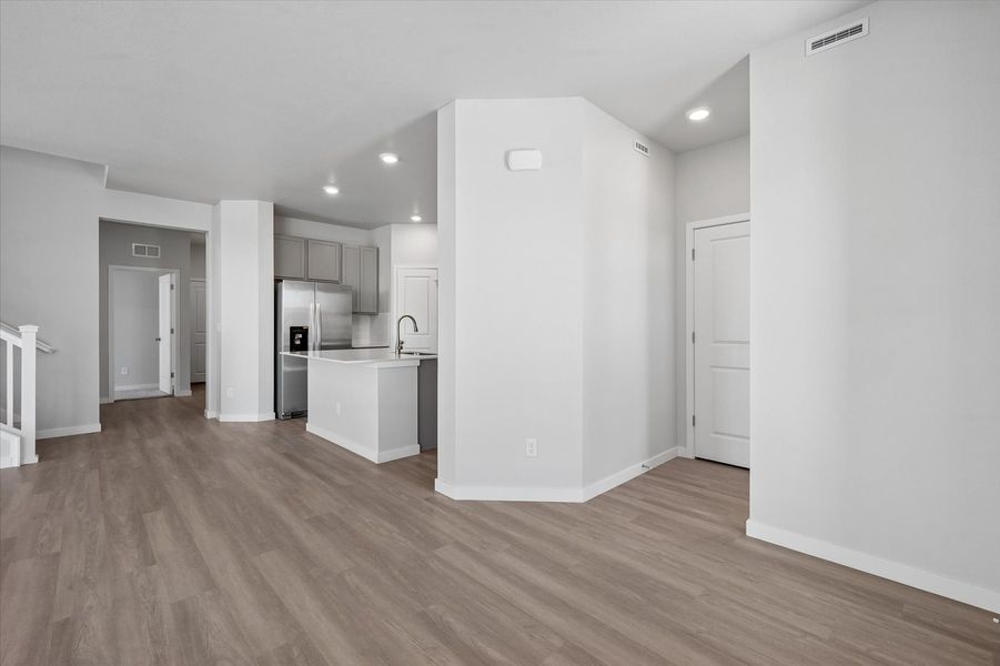 A large empty room with white cabinets.