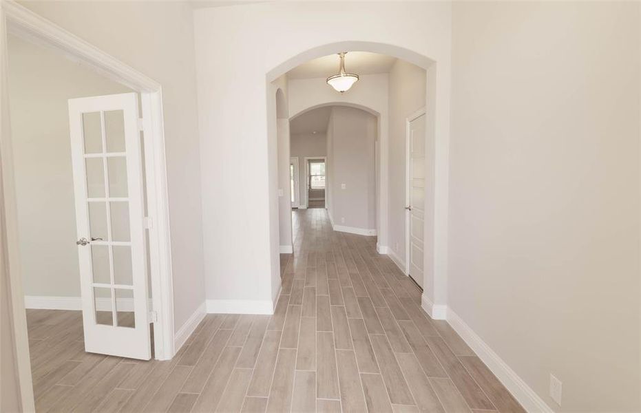 Hall featuring light wood-type flooring