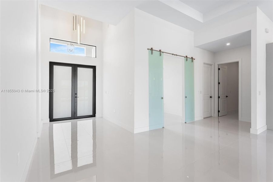 Enter through the COVERED FRONT PORCH and GRAND DOUBLE DOORS into a SOARING 16-FT FOYER, where a NEUTRAL PALETTE OF WHITE, LIGHT GRAY, and CASHMERE WELCOMES YOU HOME!