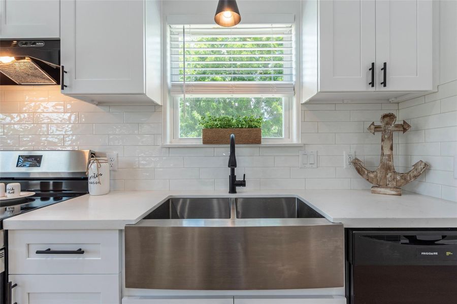 New double-pane windows throughout, 2" blinds throughout; custom hardware on cabinets, deep Farmer's sink, subway tile backsplash and upscale faucet fixture.
