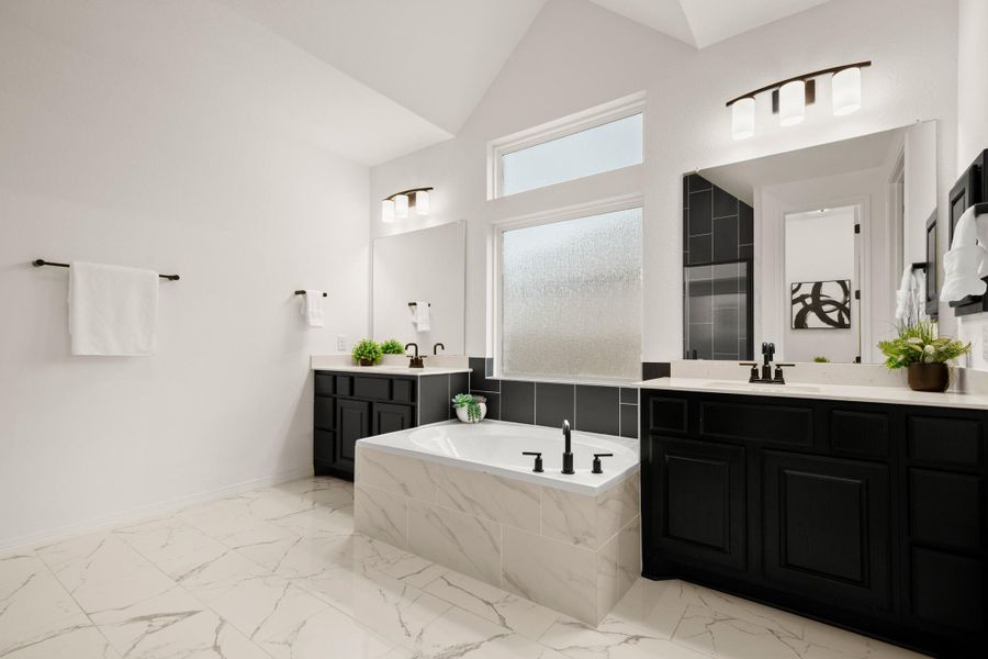 The primary ensuite bath is your daily spa getaway complete with spacious separate vanities flanking a relaxing built-in soaking tub and refined modern finishes. The primary ensuite bath is your daily spa getaway complete with spacious separate vanities flanking a relaxing built-in soaking tub and refined modern finishes.