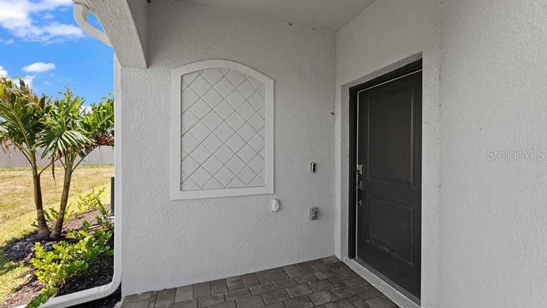 Exterior details and patio area of a home in Palm Lake at Coco Bay, Englewood (Image 3).