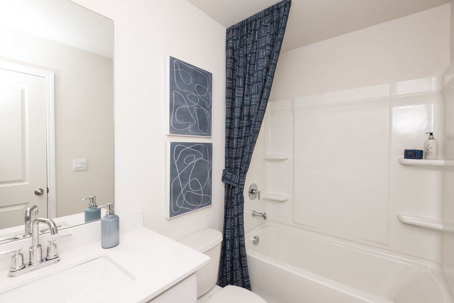 The secondary bedroom features a full, spacious bathroom.