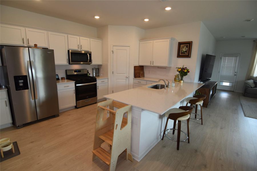 Gleaming stone countertops and a spacious breakfast island anchor this modern culinary workspace.