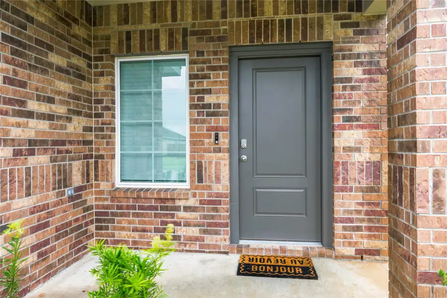 Welcoming entry — Covered front entrance with modern door. Welcoming entry — Covered front entrance with modern door.