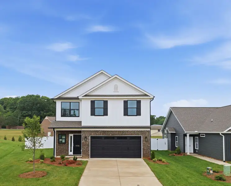 Front exterior of a new home in Sullivans Reserve, Walkertown, NC, highlighting curb appeal (Image 1). Front exterior of a new home in Sullivans Reserve, Walkertown, NC, highlighting curb appeal (Image 1).