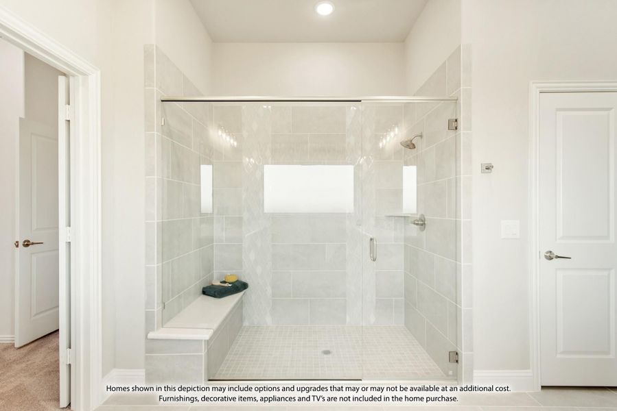 Walk-in shower with glass door, gray tile walls, built-in bench, and overhead window for natural light Walk-in shower with glass door, gray tile walls, built-in bench, and overhead window for natural light