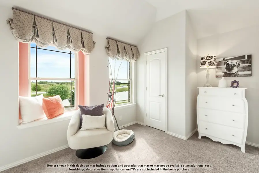 Bedroom with vaulted ceiling, window seat, accent chair, and white dresser on carpet flooring