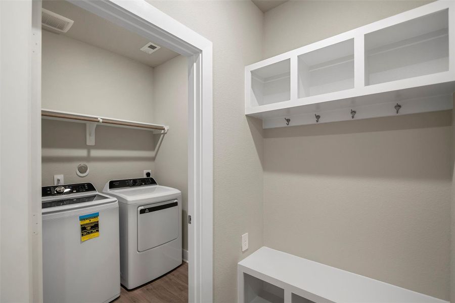 Convenient laundry space with built-in shelving for organization and storage.