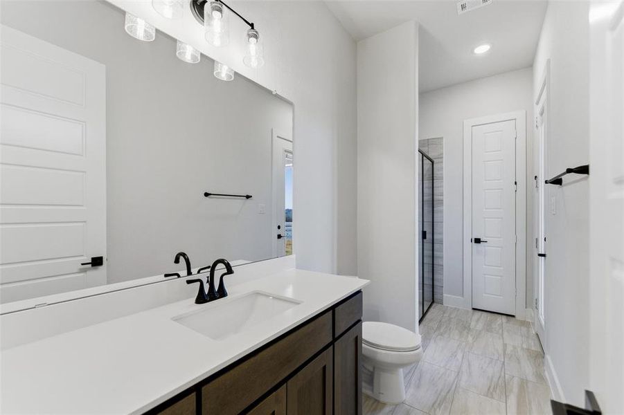 Full bath featuring a stall shower, vanity, recessed lighting, and light marble finish flooring