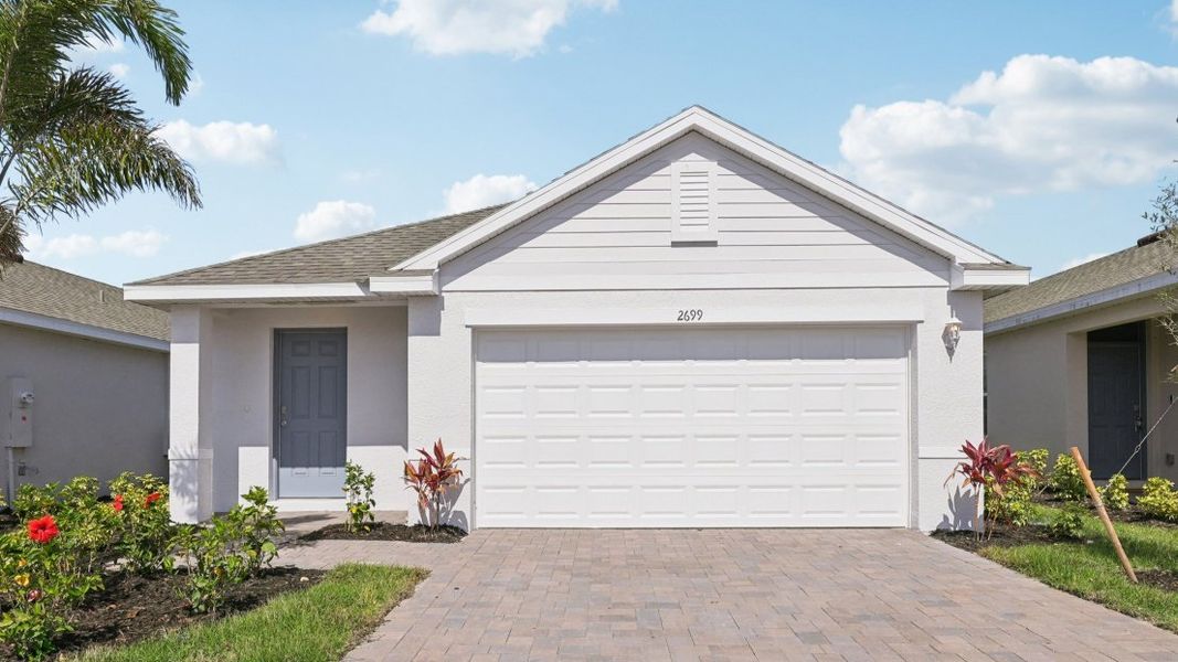 Front exterior of a new home in Coral Bay - Express & Tradition, Fort Myers, FL, highlighting curb appeal (Image 11).