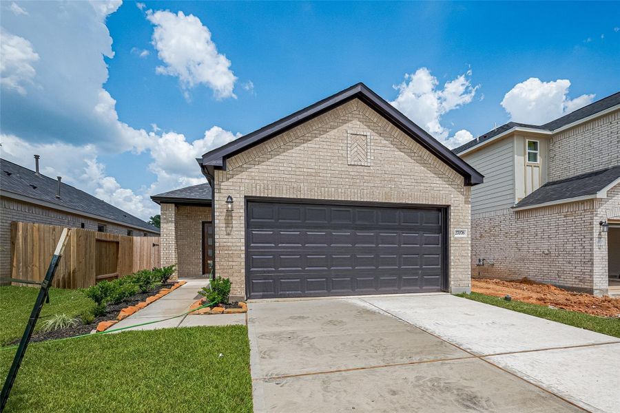Front exterior of a new home in Woodland Lakes, Huffman, TX, highlighting curb appeal (Image 1). Front exterior of a new home in Woodland Lakes, Huffman, TX, highlighting curb appeal (Image 1).
