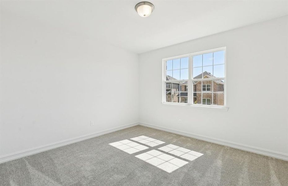 Spacious secondary bedroom with large windows