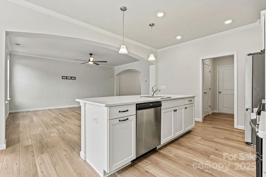 The kitchen flows effortlessly into the spacious great room for open-concept living The kitchen flows effortlessly into the spacious great room for open-concept living