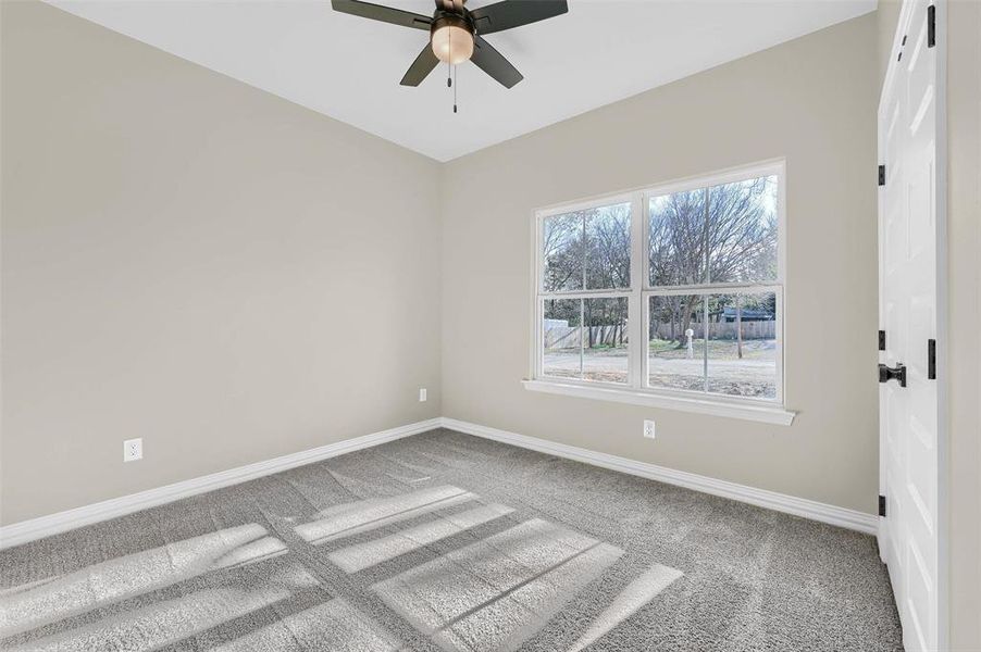 Spare room with ceiling fan and carpet floors