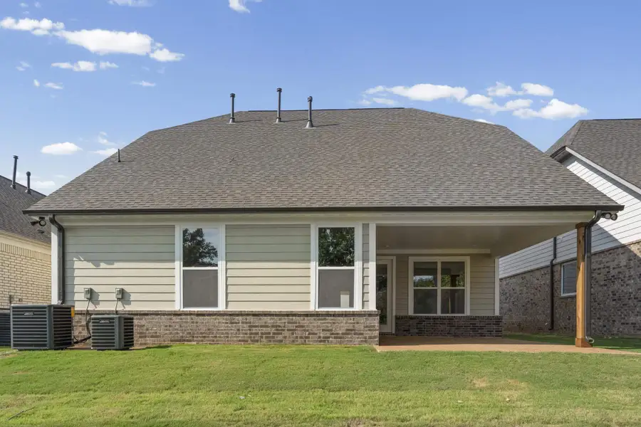 Rear exterior featuring a covered patio, brick and siding facade, and multiple windows Rear exterior featuring a covered patio, brick and siding facade, and multiple windows