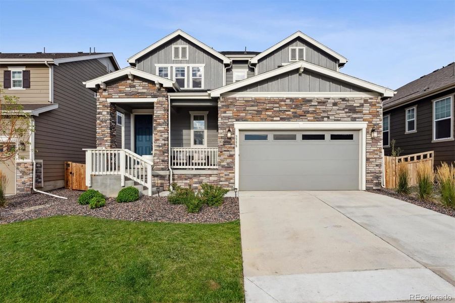 Front exterior of a new home in Sweetgrass, Dacono, CO, highlighting curb appeal (Image 23).
