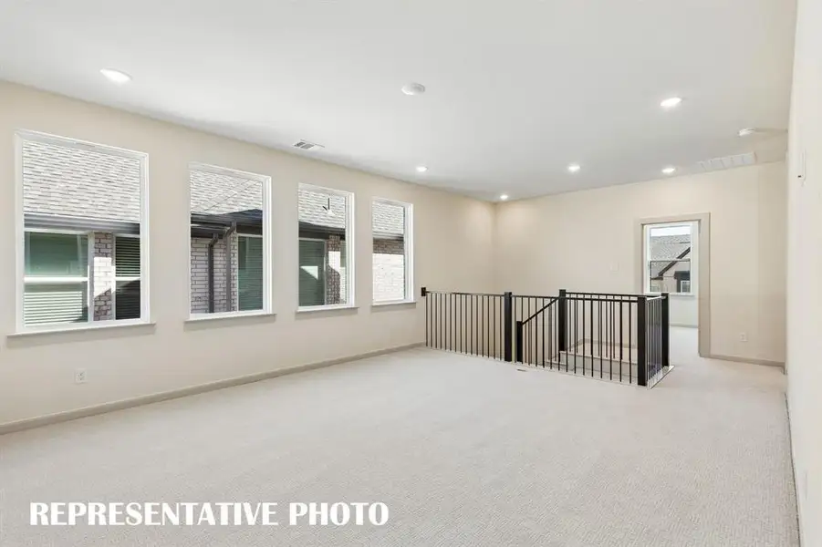 Endless hours of family fun to be enjoyed in this light and bright game room!  REPRESENTATIVE PHOTO