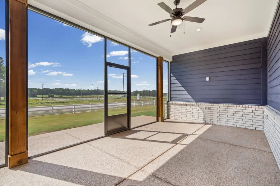 Screened porch featuring a ceiling fan, recessed lighting, white brick accents, and a plank wall
