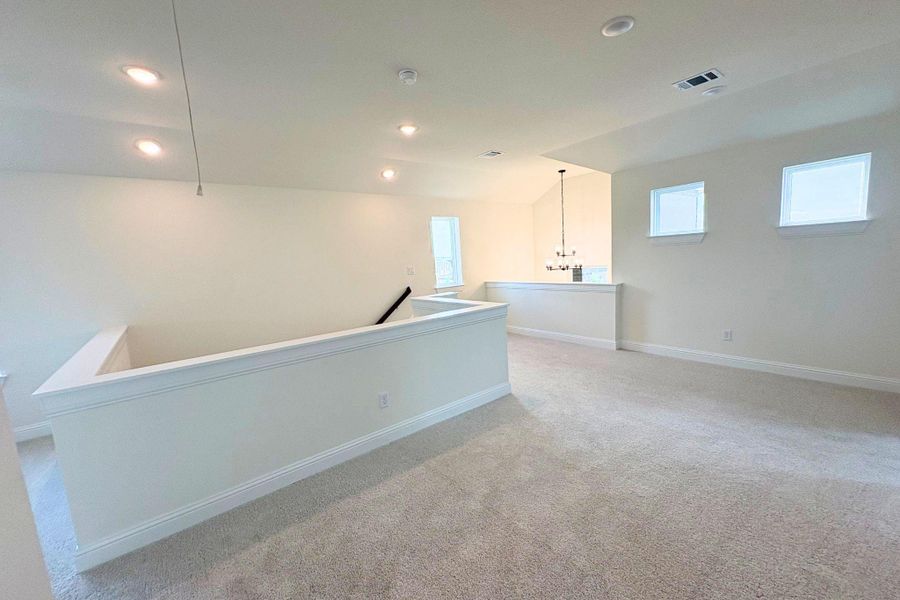 Plush carpeting and crisp white trim enhance this airy, versatile upper-level loft area. Plush carpeting and crisp white trim enhance this airy, versatile upper-level loft area.