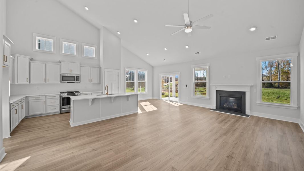 Vibrant family room with high-impact two-story ceilings and thoughtful layout for entertaining