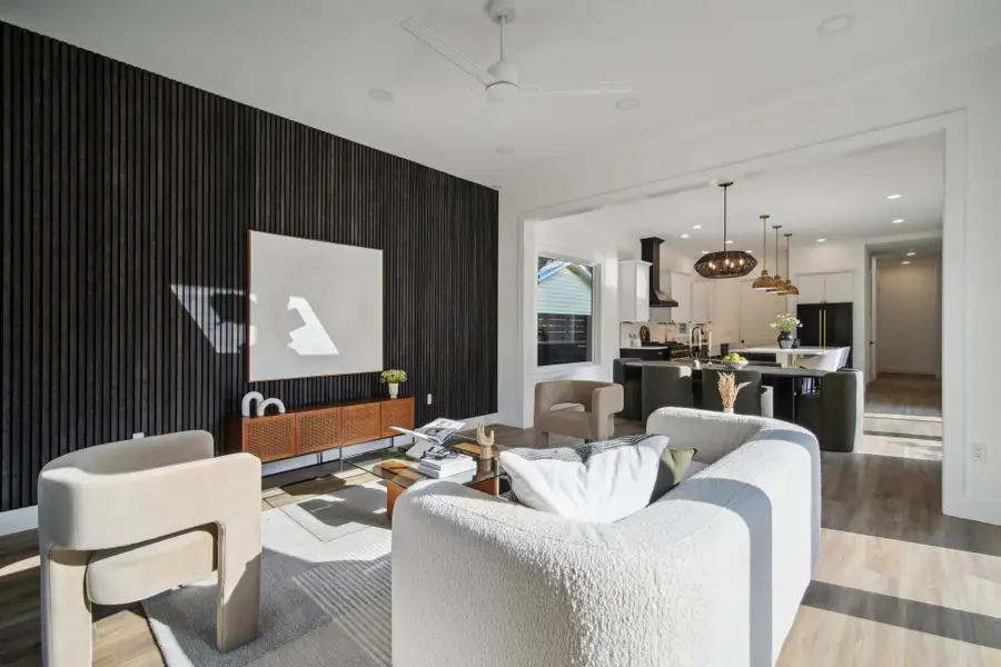 Living area featuring wood finished floors, ceiling fan, and recessed lighting
