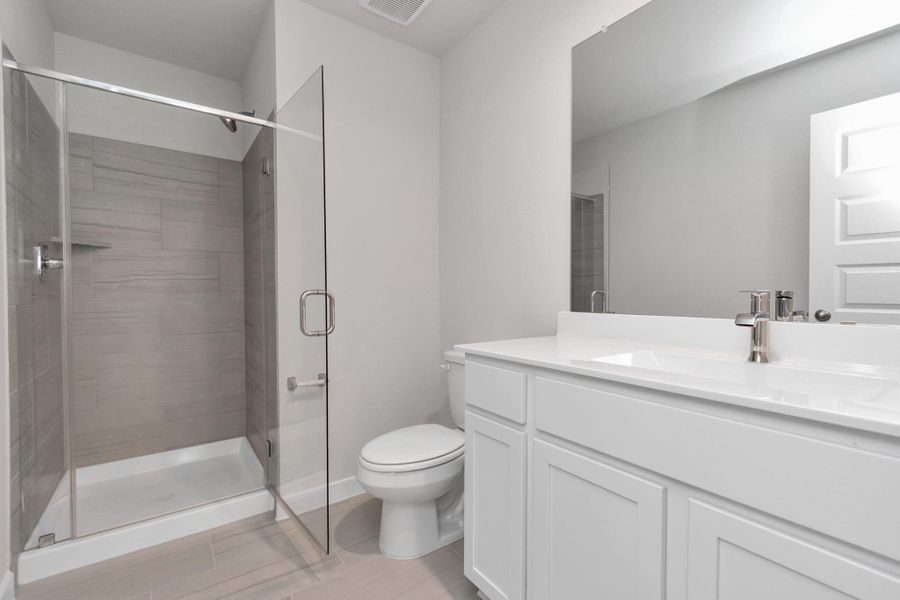 Guest bathroom with walk in shower. Sample photo of completed home with similar floor plan. Actual colors and selections may vary.