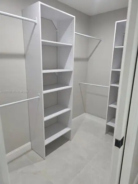 Primary walk-in closet Primary walk-in closet