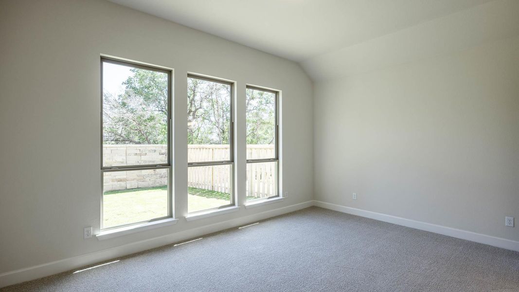 Carpeted spare room with healthy amount of natural light Carpeted spare room with healthy amount of natural light