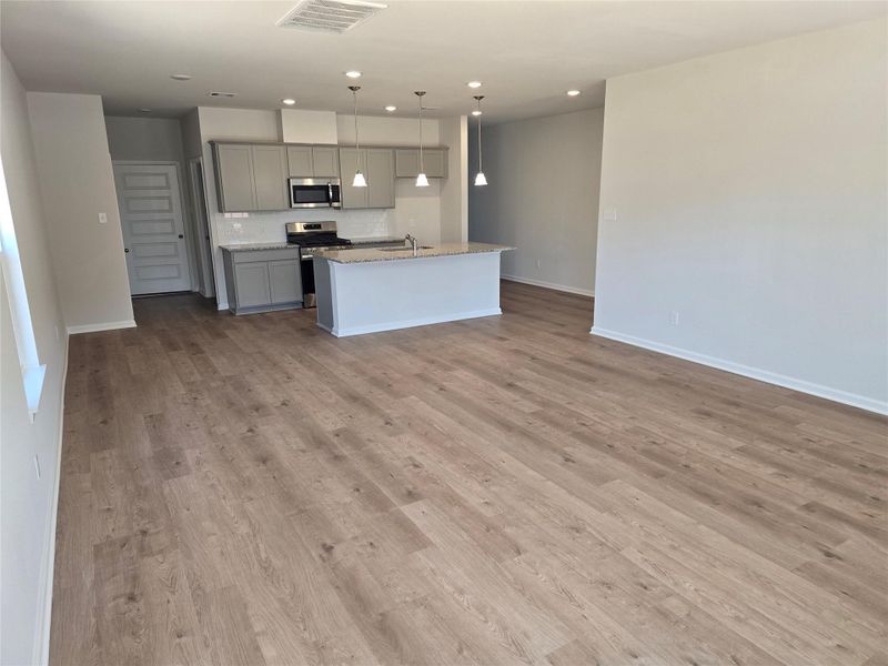 The Shetland III- Family Room into the kitchen. Home under construction. Sample floor plan photo used for illustrative purposes only. Upgrades, selections options, windows and colors may vary. The Shetland III- Family Room into the kitchen. Home under construction. Sample floor plan photo used for illustrative purposes only. Upgrades, selections options, windows and colors may vary.