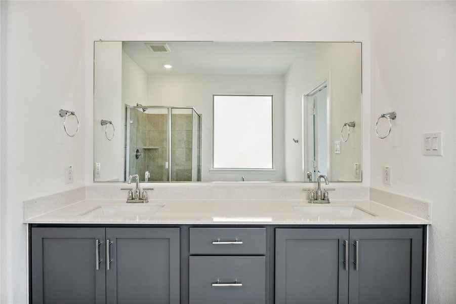 Bathroom with vanity and a shower with door