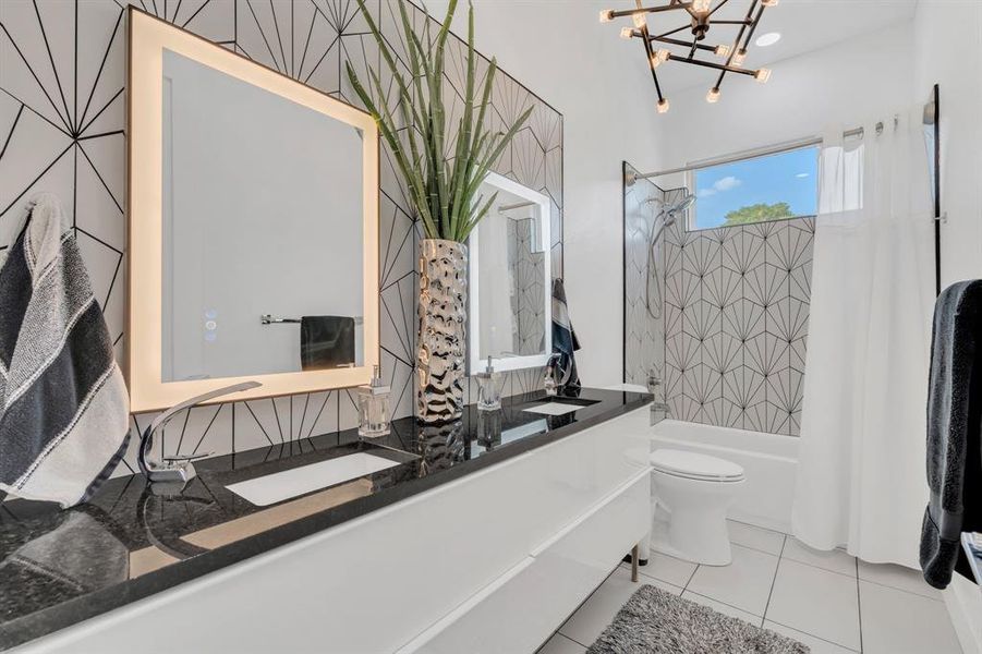 Bathroom with shower / bath combo, vanity, light tile patterned floors, and a chandelier
