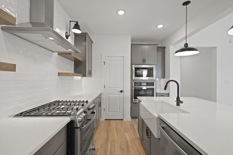 Stylish kitchen with grey cabinets and quartz counters (*Photo not of actual home and used for illustration purposes only.) Stylish kitchen with grey cabinets and quartz counters (*Photo not of actual home and used for illustration purposes only.)