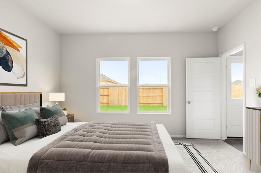 Carpeted bedroom featuring multiple windows