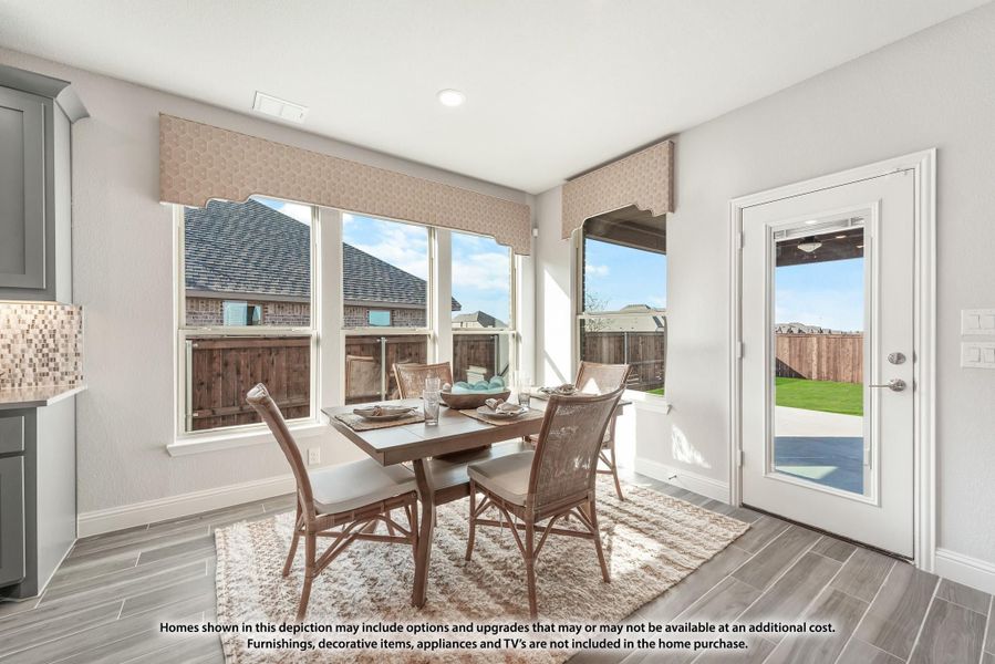 Breakfast nook with wood dining table, four chairs, large windows, and back door leading to yard Breakfast nook with wood dining table, four chairs, large windows, and back door leading to yard