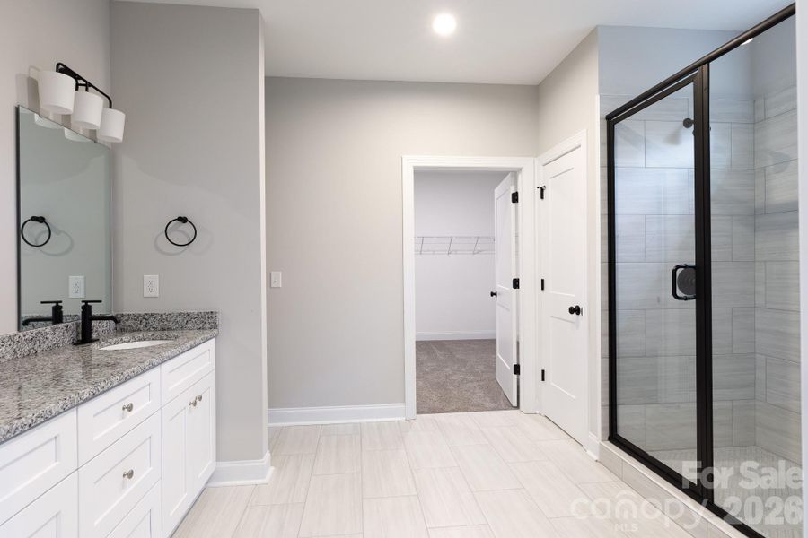 Main bath with tile floors, walk-in tiled shower and double sink. Main bath with tile floors, walk-in tiled shower and double sink.