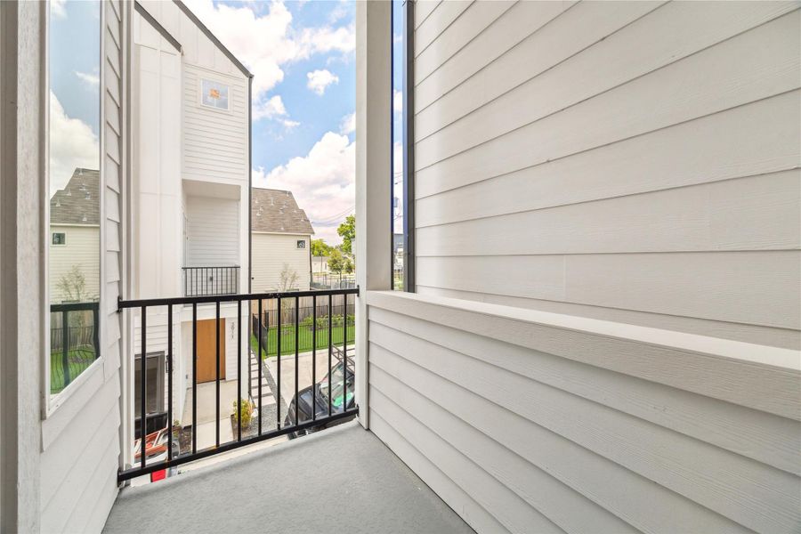 Charming balcony offering a cozy outdoor retreat with neighborhood views. Perfect for relaxing or enjoying your morning coffee.