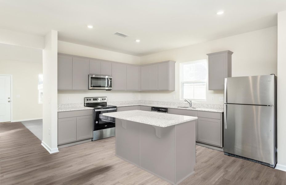 Package B Kitchen with beautiful gray cabinets and granite countertops.