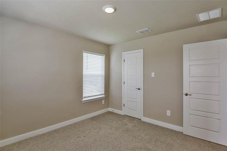Spare room featuring light carpet and baseboards Spare room featuring light carpet and baseboards