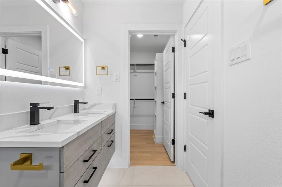 Full bath featuring double vanity and a sink