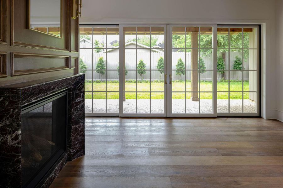 Peak from the family room through the oversized slider door out to the lushly landscaped back yard . Peak from the family room through the oversized slider door out to the lushly landscaped back yard .