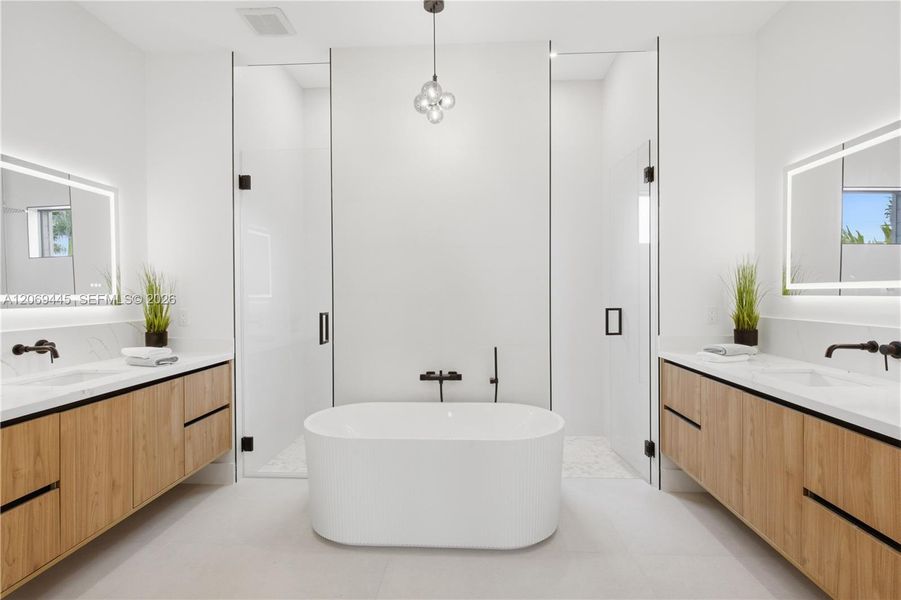 Spa-inspired ensuite w/ freestanding soaking tub, dual floating vanities, LED mirrors Spa-inspired ensuite w/ freestanding soaking tub, dual floating vanities, LED mirrors