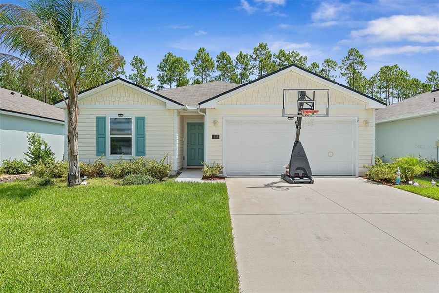 Front exterior of a new home in Sawmill Branch, Palm Coast, FL, highlighting curb appeal (Image 24).
