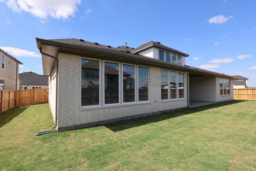 Exterior details and patio area of a home in Dunham Pointe, Cypress (Image 14).
