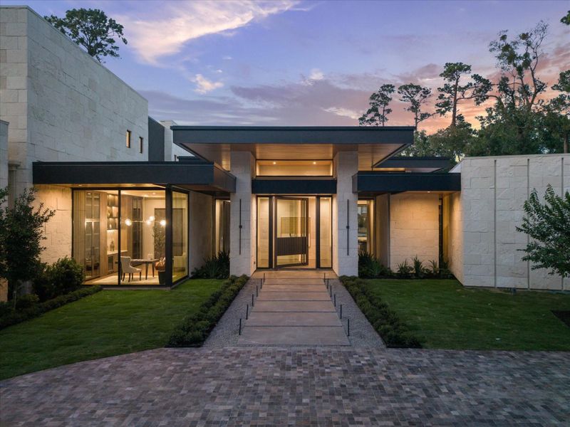 Welcome to 9010 Memorial—an unparalleled architectural statement. A custom southeast-facing glass pivot door sets the tone for refined luxury, while the grand stone entry wall creates a dramatic and artful first impression. Every detail signals exceptional craftsmanship and one-of-a-kind design.