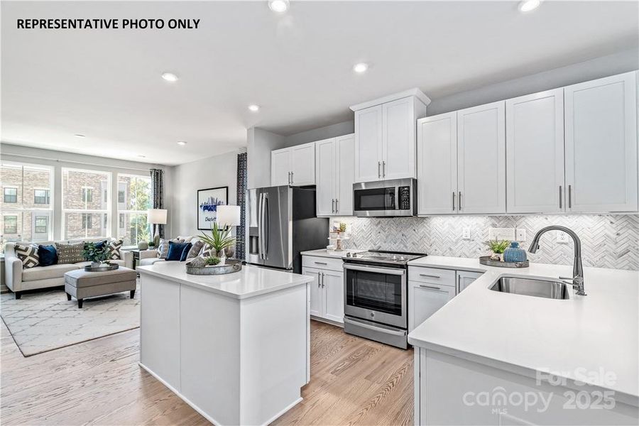 Spacious Kitchen with Island and Peninsula Overlooking the Family Room. Illustrative purposes only