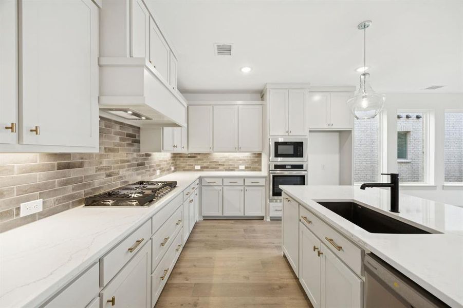 Beautiful cabinetry, gorgeous counter tops and designer backsplash effortlessly combine with the contemporary stainless steel appliances to create the kitchen of your dreams! Beautiful cabinetry, gorgeous counter tops and designer backsplash effortlessly combine with the contemporary stainless steel appliances to create the kitchen of your dreams!