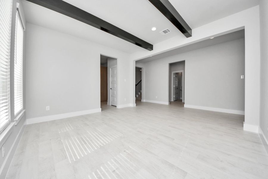 Craft enduring memories with loved ones around the table in this roomy dining area. It boasts stylish flooring, personalized paint, and is conveniently situated next to the family room and kitchen, fostering an open and inclusive ambiance.