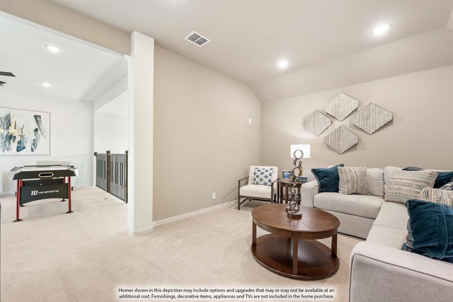 Upstairs loft with sectional sofa, round coffee table, and game table near staircase railing Upstairs loft with sectional sofa, round coffee table, and game table near staircase railing